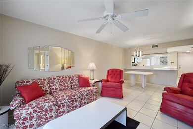 Living room with light tile patterned floors and c