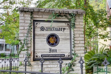 Exterior Sign and Wrought Iron Fence