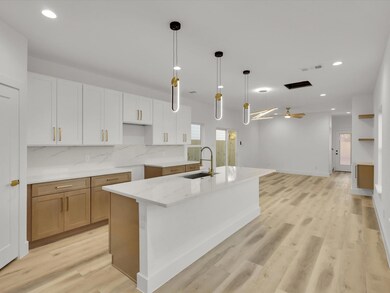 Kitchen featuring ceiling fan, a spacious island, 