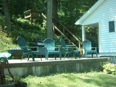 Exterior Front. Stairs from road and side patio ar