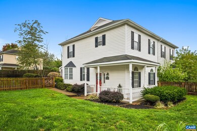 Fully fenced yard, front porch in view.