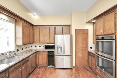 The kitchen has recent appliances and canned light