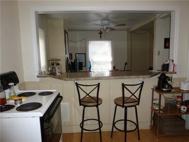 Upper unit kitchen open to living room.