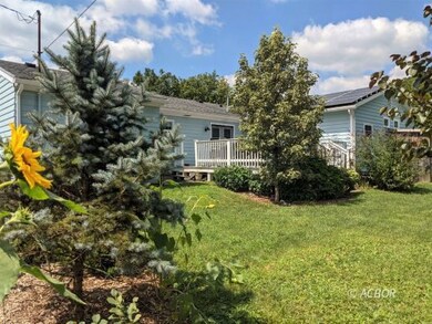 Back of house with gardens, solar, deck
