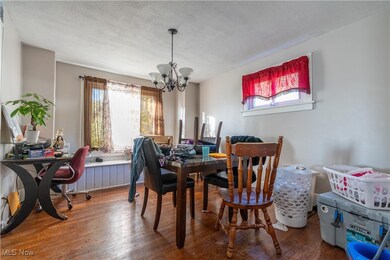 Dining room with a window seat and chandelier.
