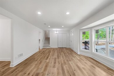 Unfurnished living room featuring baseboards, visi