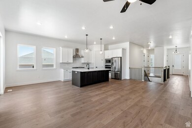 Kitchen with open floor plan, light countertops, stainless steel appliances, and recessed lighting