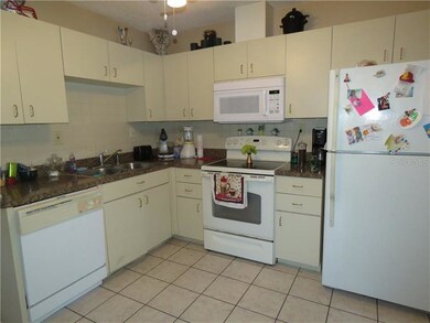 Kitchen has glass top range, dishwasher, microwave