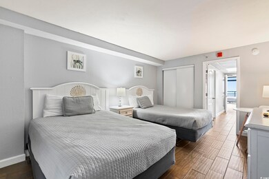 Bedroom featuring baseboards, a closet, and wood f
