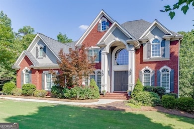 View of front facade featuring brick siding, a front lawn, and a shingled roof