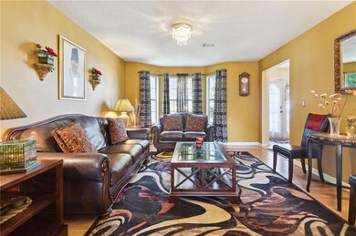 Living room with a textured ceiling and light hard
