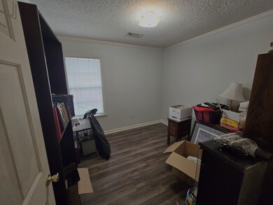 Bedroom with a textured ceiling, ornamental moldin