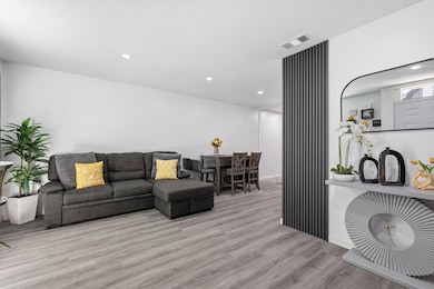 Living room featuring wood finished floors and recessed lighting