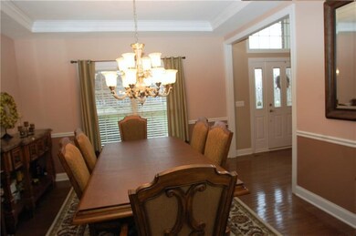 With a trey ceiling, chair rail and hardwood floor