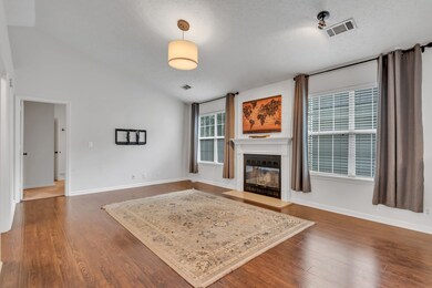 What a wonderful family room with cozy fireplace and lots of light