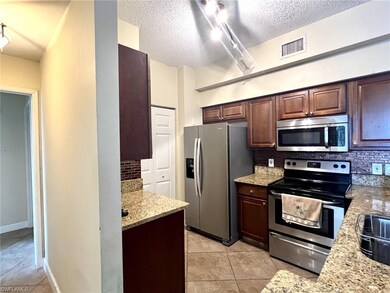 Kitchen featuring visible vents, backsplash, and s