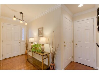 Entry with hardwood and updated lighting