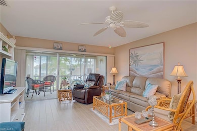 Living room with light wood-style floors and ceiling fan