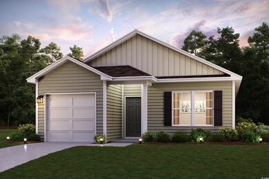 View of front of house featuring a yard and a gara