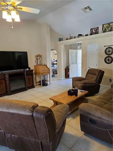 Living area featuring arched walkways, a ceiling f