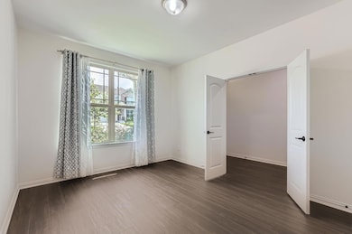 Empty room featuring dark wood finished floors an