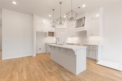 Kitchen featuring visible vents, an inviting chand