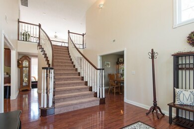 Beautiful craftsmanship on this curved staircase as you enter into this  gorgeous home!