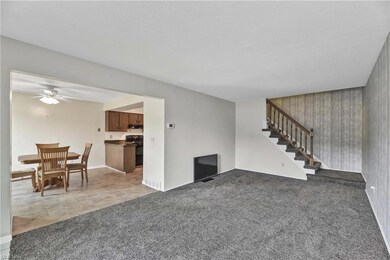 Unfurnished living room featuring plush dark grey 