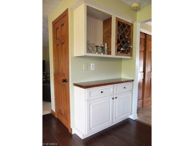 Kitchen has a built-in wine rack and a walk-in pan