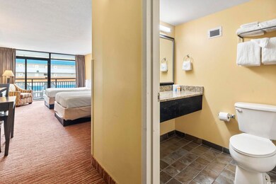 Bathroom featuring toilet and a wall of windows