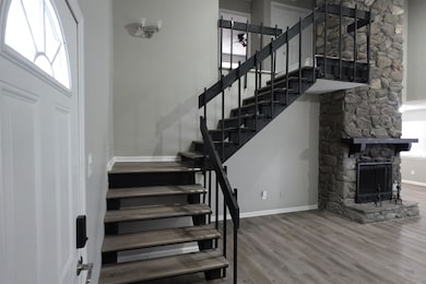 Stairs featuring baseboards, wood finished floors,