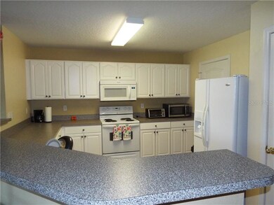 Spacious kitchen with white appliances