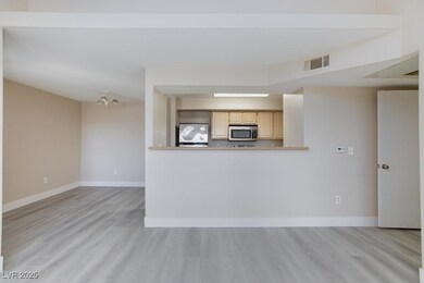 Kitchen with stainless steel microwave, light wood