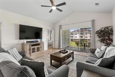 Living room with lofted ceiling, ceiling fan, and 