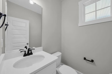 Half bathroom with toilet and vanity