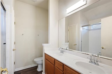 Bathroom with wood finished floors, double vanity
