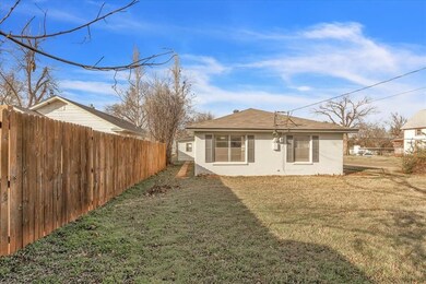 Back of property featuring a yard