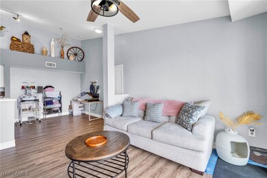Living room with ceiling fan and light hardwood /