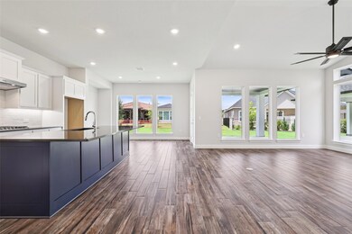 Kitchen featuring open floor plan, dark wood-styl