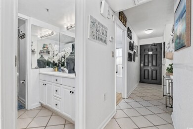 Hallway featuring light tile patterned floors