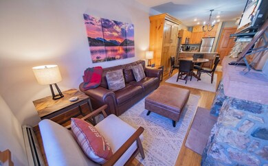 Living room featuring a notable chandelier, light