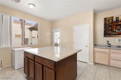 Kitchen featuring a center island, light tile patt