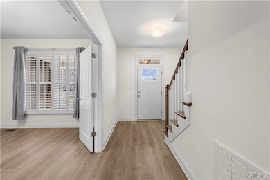 Entrance foyer featuring light wood-type flooring,