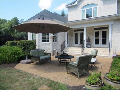 Rear of home has a covered porch and 2 patios for entertaining.