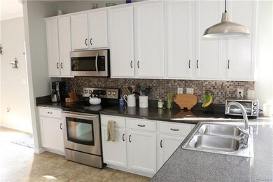 Kitchen with tile backsplash and under cabinet lig