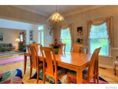 The formal dining room is elegant and features cro