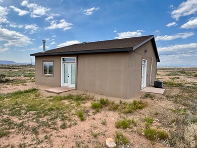 Rear view of property with french doors and a mountain view