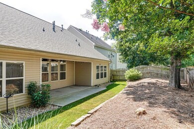 Rear view of property featuring a patio, a fenced backyard, and a shingled roof