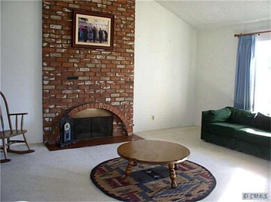 Living room with brick fireplace.
