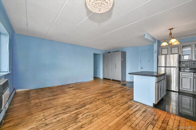 Kitchen featuring a center island, freestanding refrigerator, tasteful backsplash, a chandelier, and open floor plan